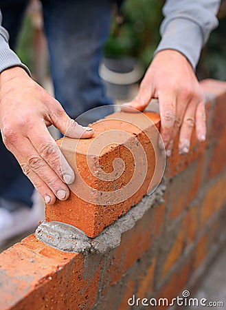 Everything is built one brick at a time. a master bricklayer at work. Stock Photo