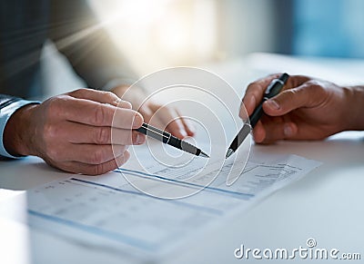 Everything detail accounted for. two unrecognizable businessmen discussing paperwork at the table in the boardroom. Stock Photo