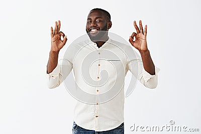 Everything is excellent. Satisfied attractive african american male businessman in white shirt showing okay or ok Stock Photo