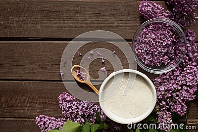 Everything prepared for homemade lilac sugar - Purple lilac flower, wooden spoon, sugar Stock Photo