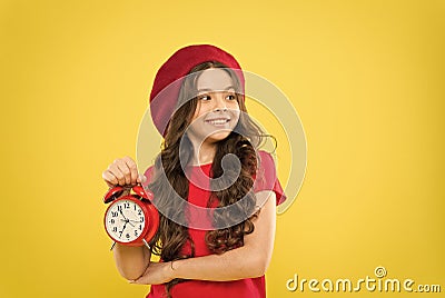 Everything is under control. Define own rhythm of life. Schedule and time. Set up alarm clock. Child little girl hold Stock Photo
