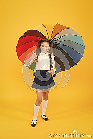 Everything under control. Fancy schoolgirl. Girl with umbrella. Rainy day. Happy childhood. Rainbow umbrella. Kid happy Stock Photo