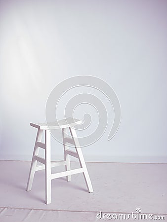 Everything white. White stool, wall & whiteish floor Stock Photo
