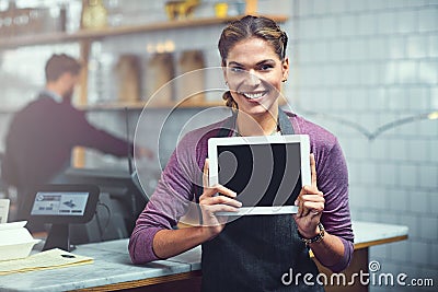 Everything your read on our blog is true. Portrait of a young woman showing a blank screen on a digital tablet in her Stock Photo