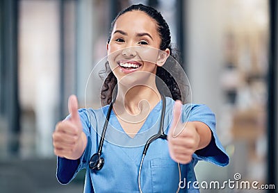 Everythings going to be just fine. a young female doctor showing a thumbs up at a hospital. Stock Photo