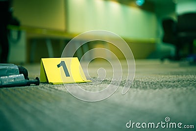 Evidence marker number 7 on carpet floor near suspect object in Stock Photo