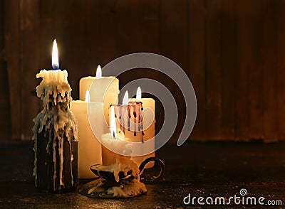 Evil candles on wooden background Stock Photo