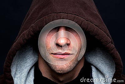 Evil looking hooded man Stock Photo