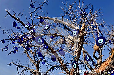 Evil nazar eye talismans tree near Pigeon valley, beautiful canyon in Cappadocia,Turkey. Stock Photo