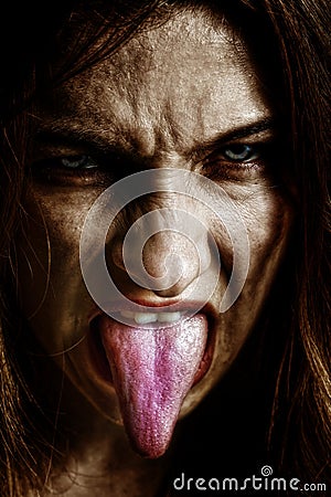 Evil scary sinister woman with tongue out Stock Photo