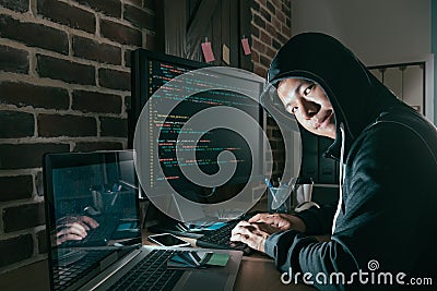 Evil young computer programmer as hacker Stock Photo