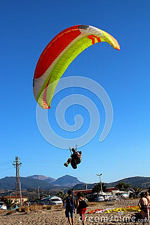 Paraglider landing on a beach with blue sky Editorial Stock Photo