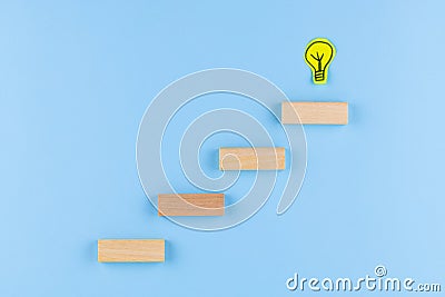 Evolving idea concept with light bulb on steps drawn Stock Photo