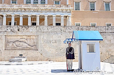 Evzones sitting on guard in front of the Greek Parliament. Editorial Stock Photo