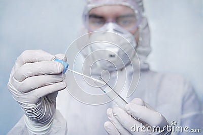 Examination of mucosal smears. The scientist is holding a test tube. Study of viruses in sputum of the lungs. Test for Stock Photo