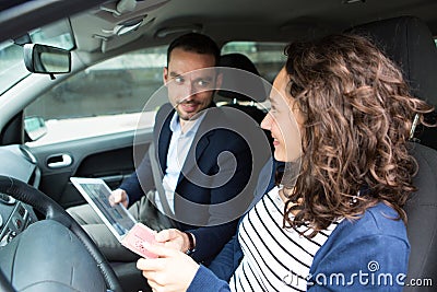 Examiner delivering driing licence to woman Stock Photo