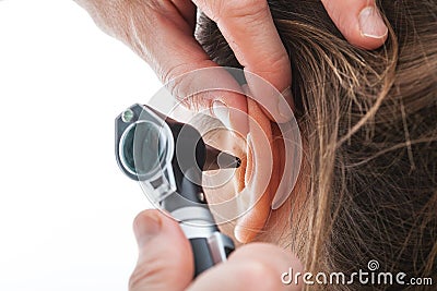 Examining ear with otoscope Stock Photo