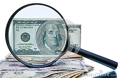 Example of a counterfeit bill and magnifier Stock Photo