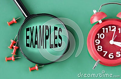 EXAMPLES - word on magnifying glass on a green background with a red clock Stock Photo