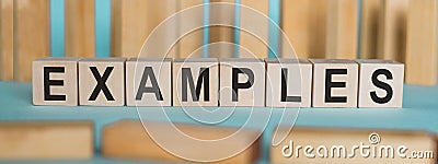 EXAMPLES word written on wooden blocks on light blue background Stock Photo