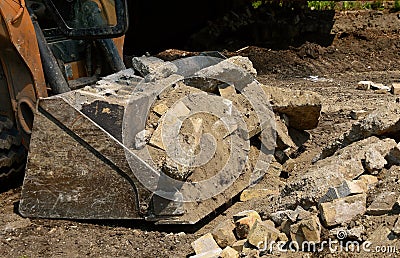 Excavating bucket full of concrete debris Stock Photo