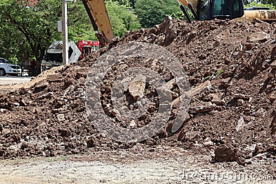 Excavation of large piles of soil in the outdoor industrial construction site. Stock Photo