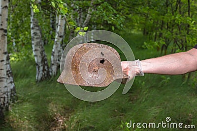 Digging in the forest. The German helmet M35. Imitation. WW2 recovery. Russia. Stock Photo