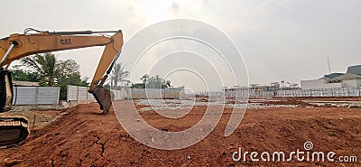 Excavator bucket being used for ground-level work in cluster housing construction project during day time. Editorial Stock Photo