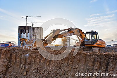 Excavator CASE CX210 working at construction site. Construction machinery for excavating, loading, Editorial Stock Photo