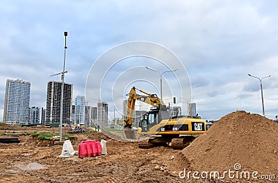 Excavator CATERPILLAR working at construction site. Construction machinery for excavation, loading, lifting and hauling of cargo Editorial Stock Photo