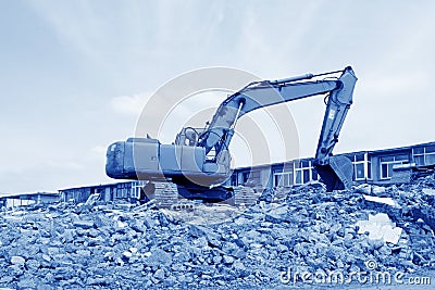 Excavator cleaning construction waste Stock Photo