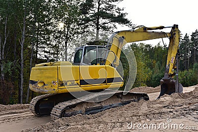 Excavator during construction new road in forest area. Backhoe at groundwork. Earth-moving equipment fort road work, grading, pool Stock Photo