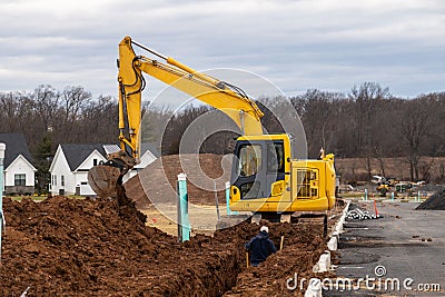 excavator digging a trench Stock Photo