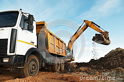 Excavator and dumper at loading Stock Photo