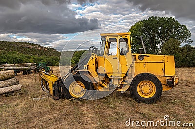 Excavator with grapple for transporting logs in a forestry operation Stock Photo