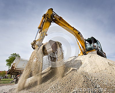Excavator on the gravel pile Editorial Stock Photo
