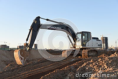 Excavator Hidromek HMK 220 LC working at construction site. Construction machinery for excavation, loading, lifting and hauling of Editorial Stock Photo