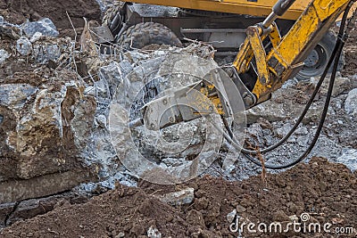Excavator with hydraulic hammer breaking concrete 3 Stock Photo
