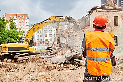 Excavator crasher machine at demolition on construction site Stock Photo