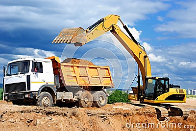 Excavator loading dumper truck Stock Photo