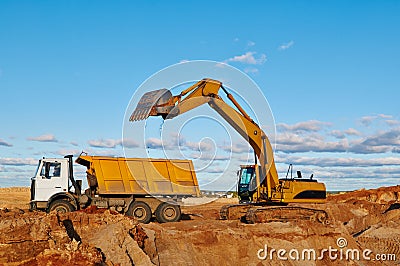 Excavator loading dumper truck Stock Photo