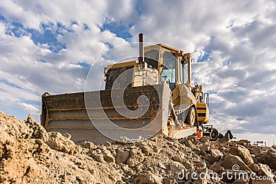 Excavator moving rock and earth in a construction place Stock Photo