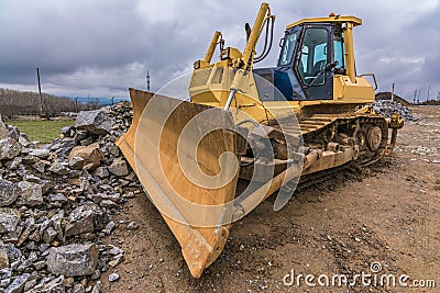 Excavator moving stone at a construction site Stock Photo