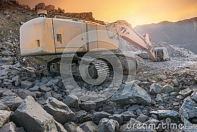 Excavator moving stone and rock at a construction site Stock Photo