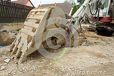 Excavator ploughshare on trench - constructing canalization Stock Photo