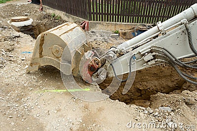 Excavator ploughshare on trench - constructing canalization Stock Photo