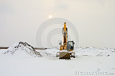 Excavator in Snow Stock Photo