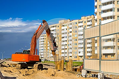 Excavator to hammer steel piles, construction road Stock Photo