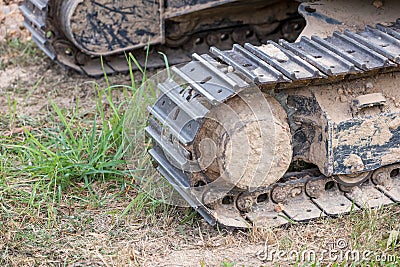 Excavator tracks. Old iron caterpillars of the bulldozer of the tractor on the road. bulldozer caterpillar tracks. Black caterpill Stock Photo