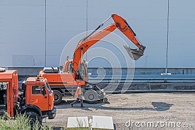 Excavator, truck and foreman at construction site Editorial Stock Photo